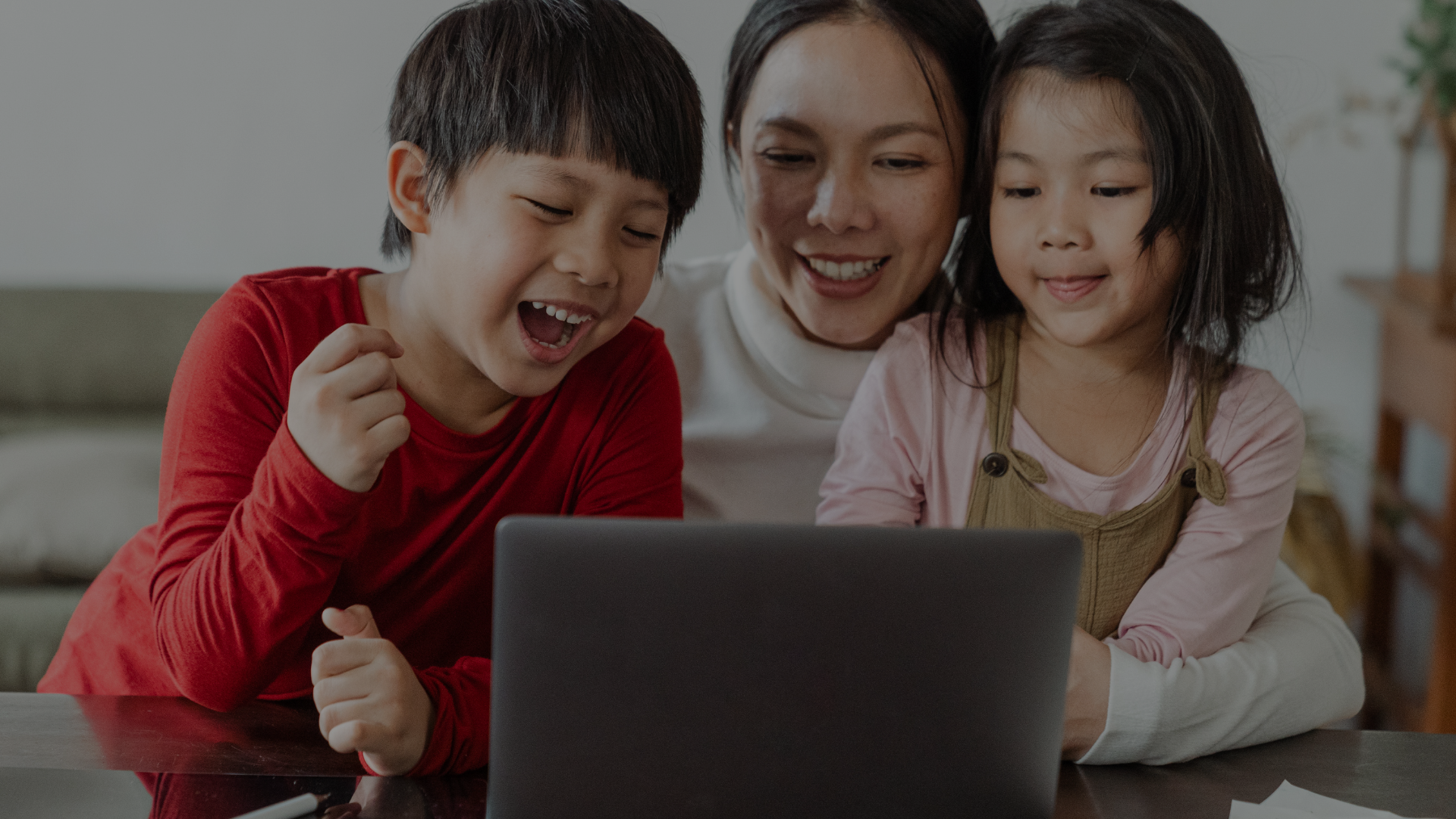 Young girl with headphones smiling during online elementary school class